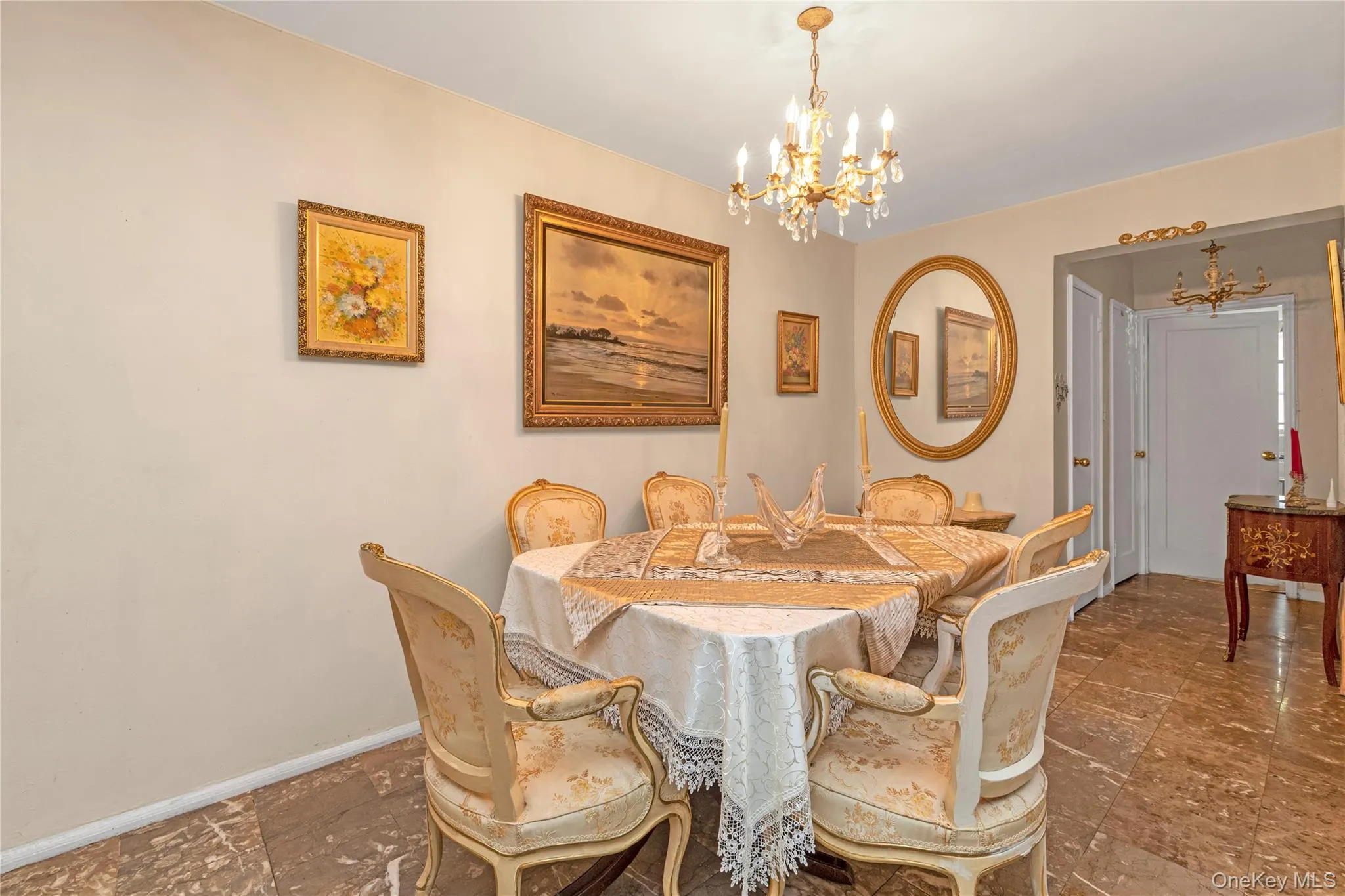 Dining room featuring a chandelier and stone finish floors Dining room featuring a chandelier and stone finish floors