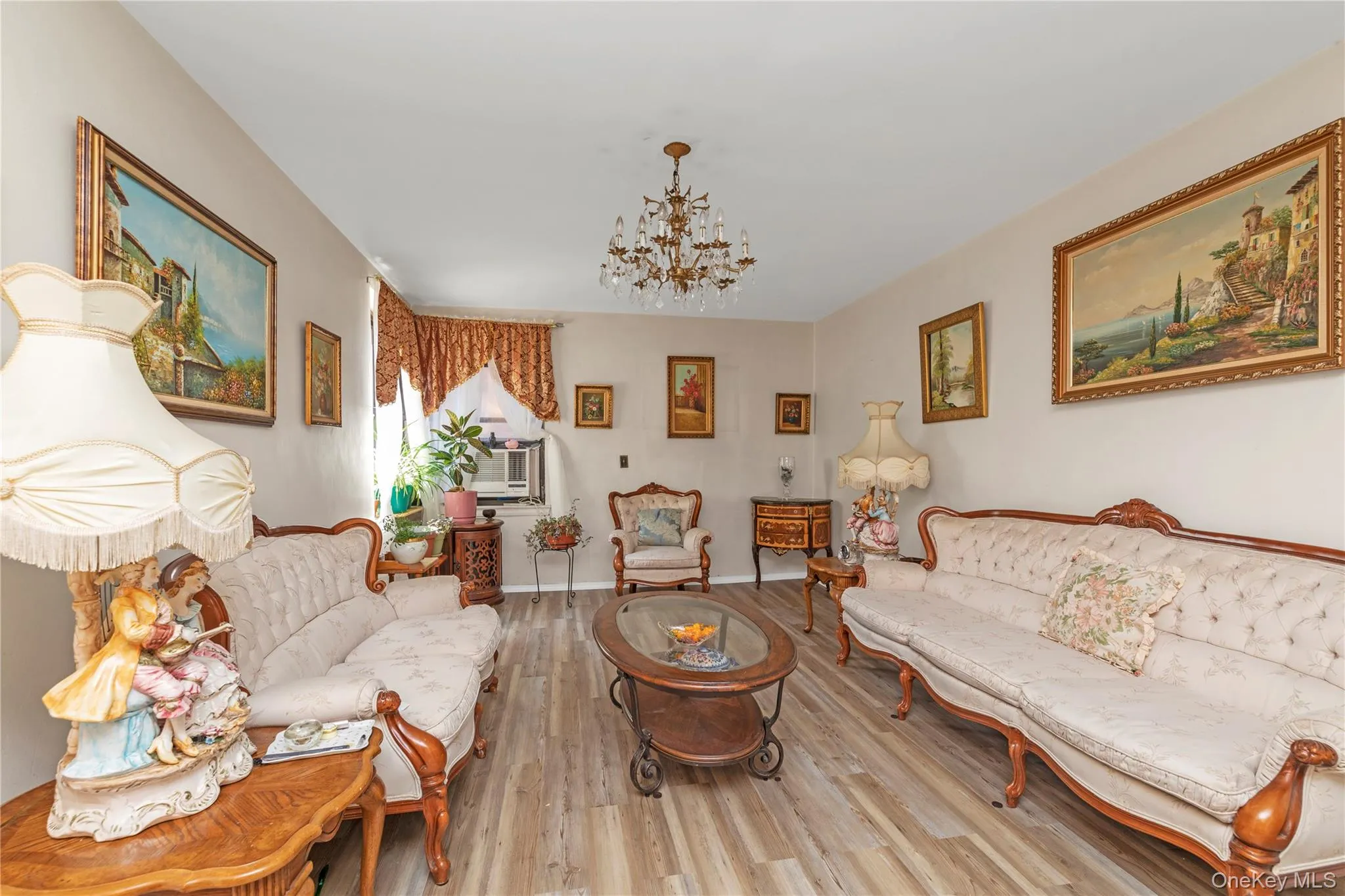 Living area with wood finished floors and a chandelier Living area with wood finished floors and a chandelier