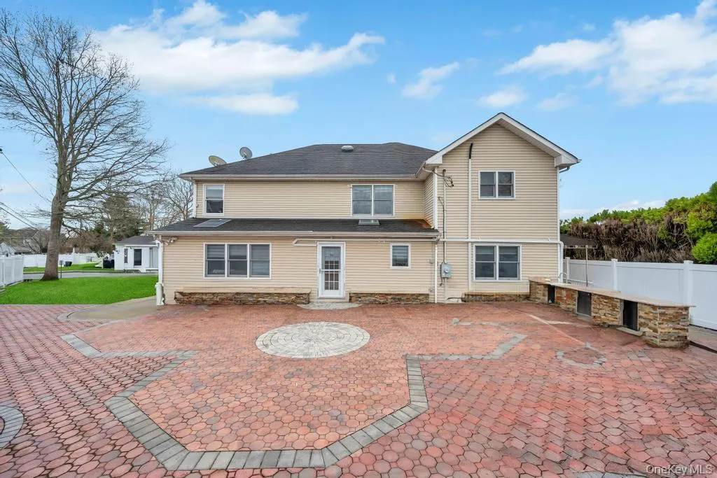 Rear view of house with a patio area and fence Rear view of house with a patio area and fence