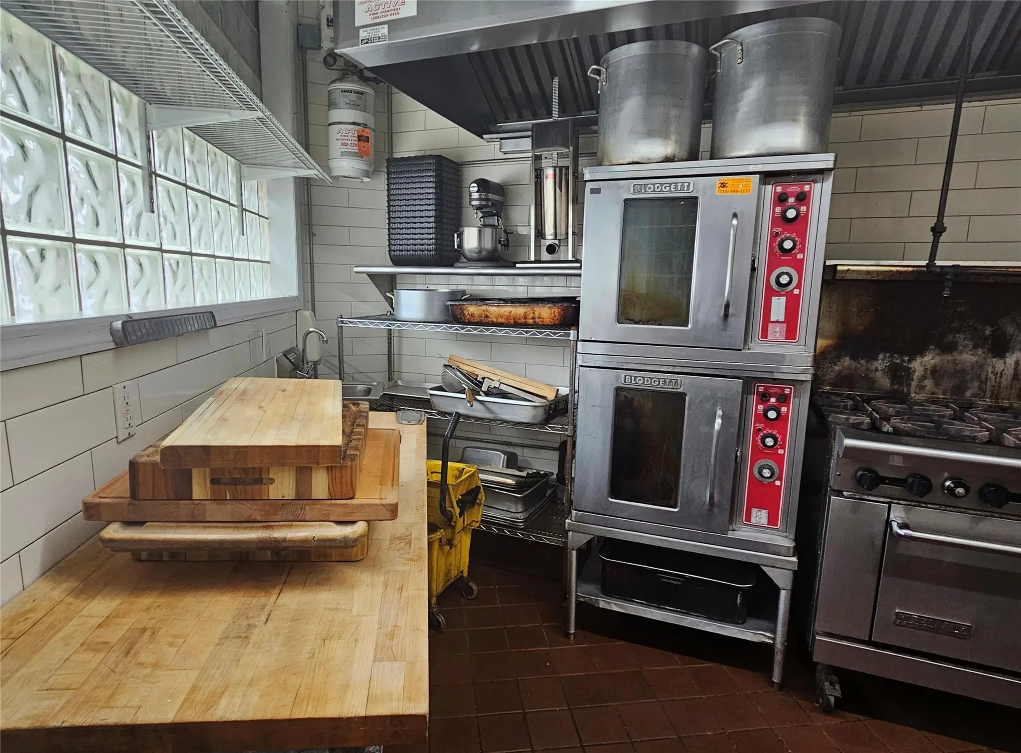 Kitchen with a warming drawer, high end stainless steel range, and backsplash Kitchen with a warming drawer, high end stainless steel range, and backsplash