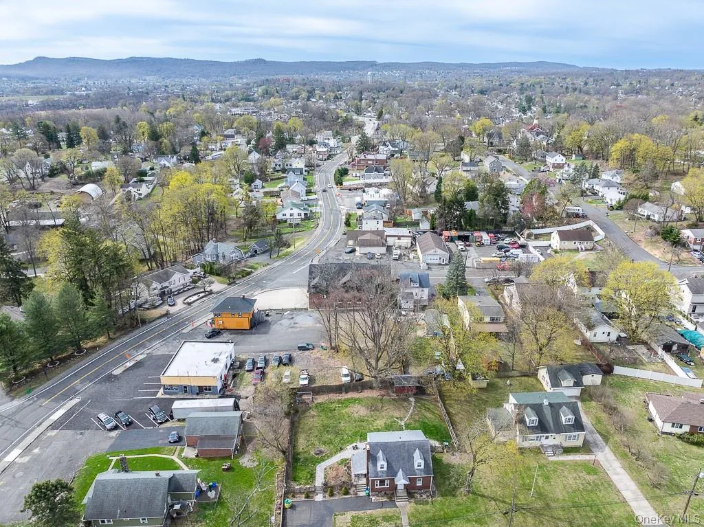 Birds eye view of property featuring a mountain view and a residential view Birds eye view of property featuring a mountain view and a residential view