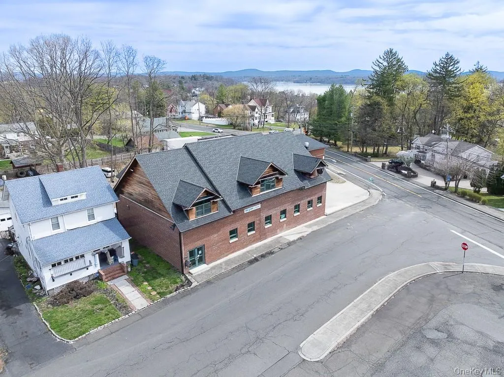 Birds eye view of property with a water and mountain view and a residential view Birds eye view of property with a water and mountain view and a residential view