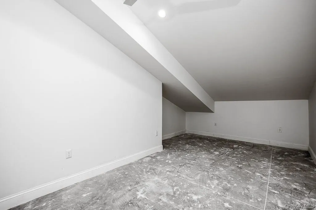 Bonus room with baseboards and lofted ceiling Bonus room with baseboards and lofted ceiling