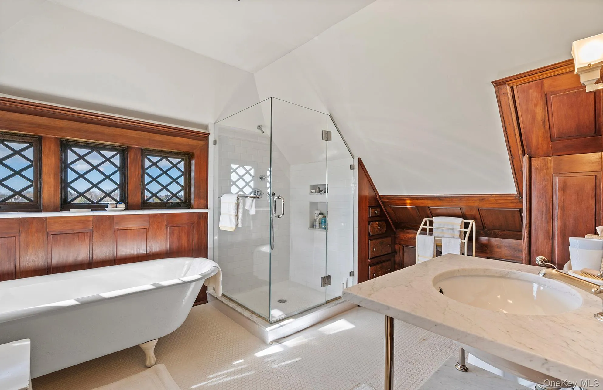 Bathroom with a shower stall, tile patterned flooring, a sink, and a soaking tub Bathroom with a shower stall, tile patterned flooring, a sink, and a soaking tub