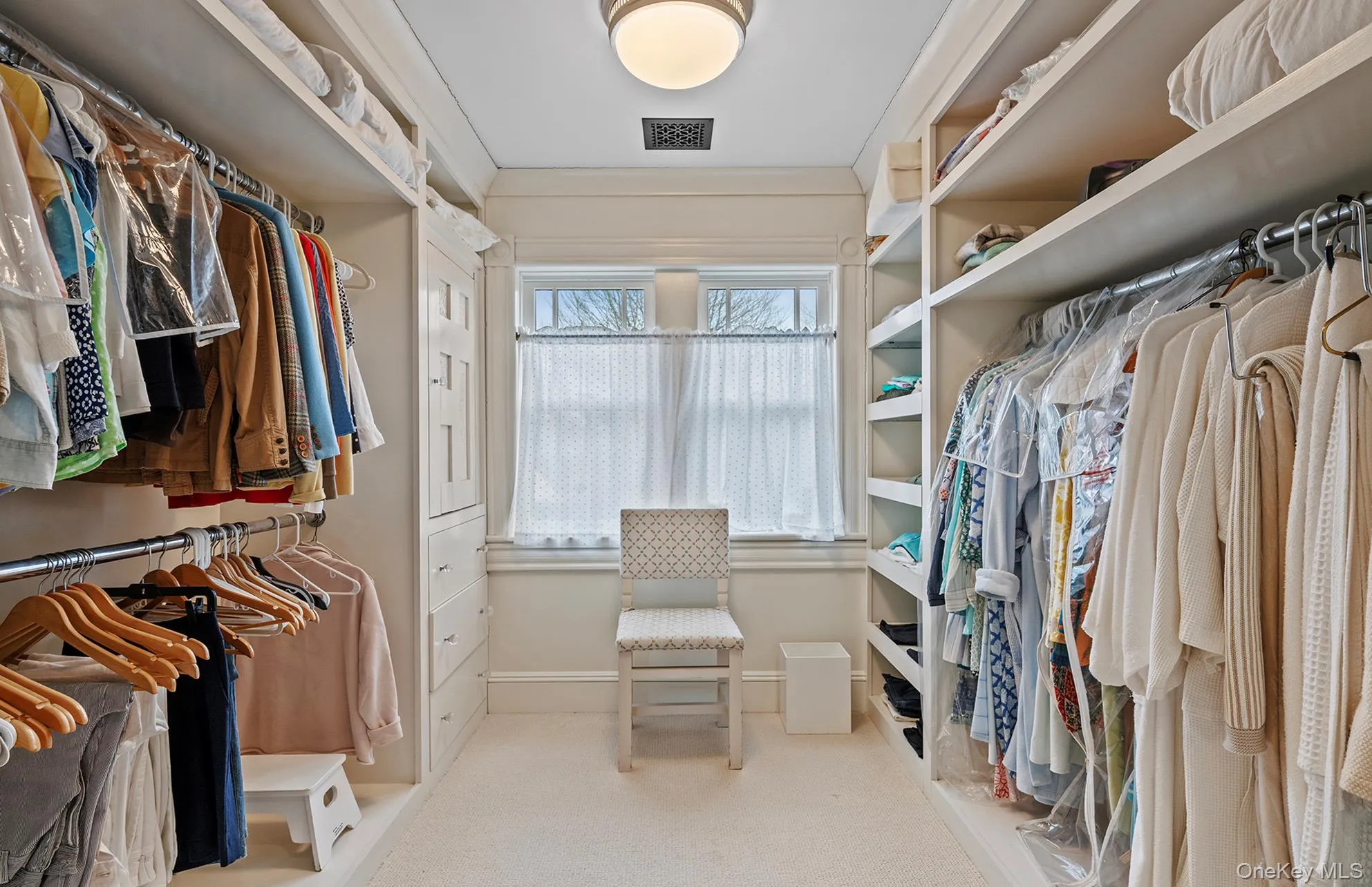Walk in closet featuring carpet and visible vents Walk in closet featuring carpet and visible vents