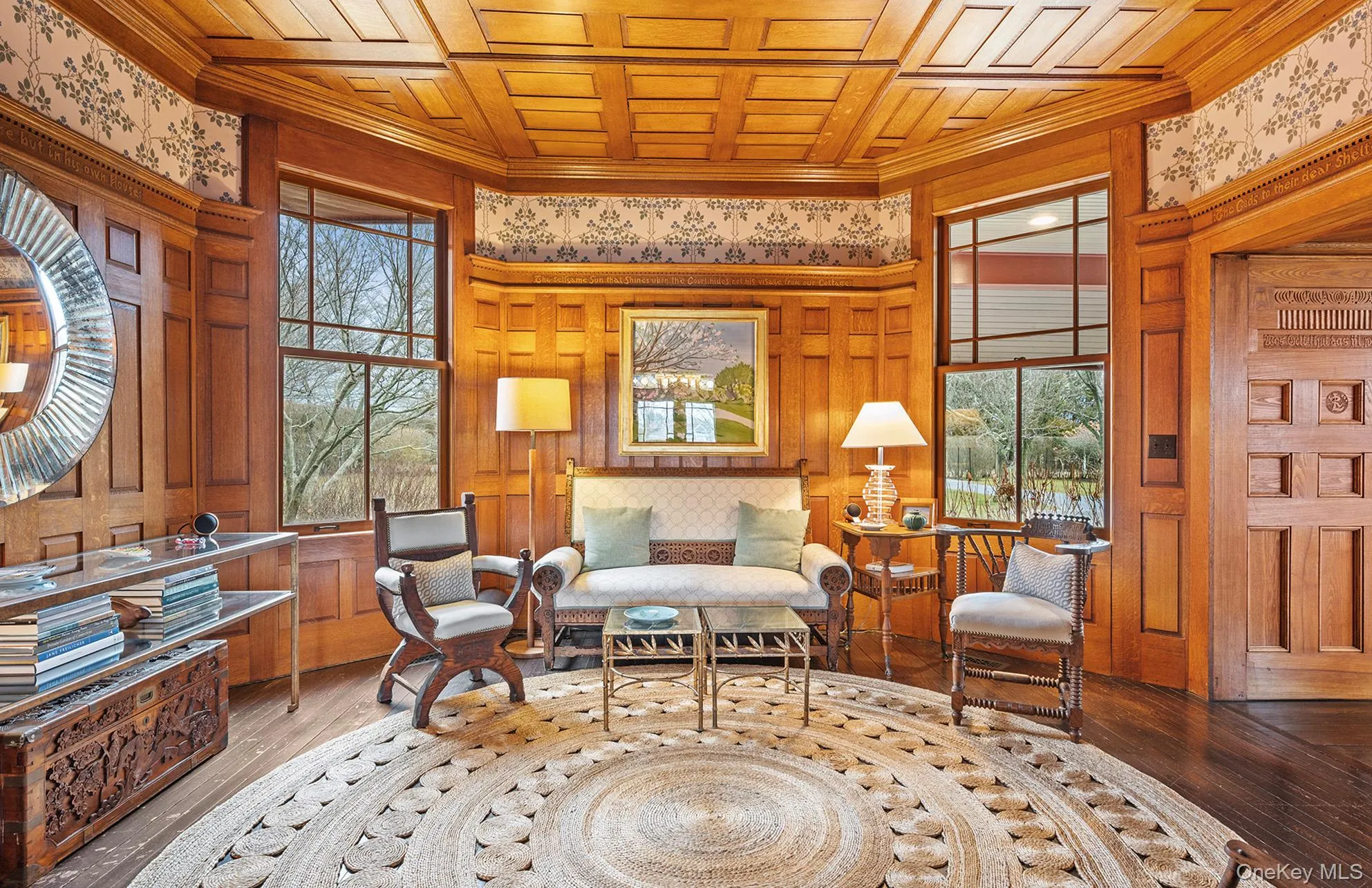 Living area with plenty of natural light, wooden ceiling, and wood finished floors Living area with plenty of natural light, wooden ceiling, and wood finished floors
