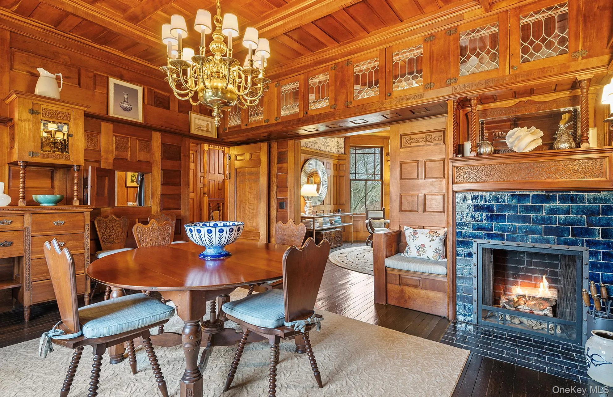 Dining space featuring a chandelier, wood ceiling, wood walls, and hardwood / wood-style flooring Dining space featuring a chandelier, wood ceiling, wood walls, and hardwood / wood-style flooring