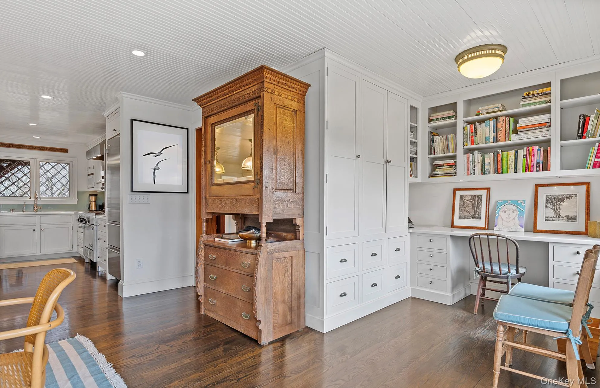 Office featuring a sink, built in study area, dark wood-style floors, and baseboards Office featuring a sink, built in study area, dark wood-style floors, and baseboards