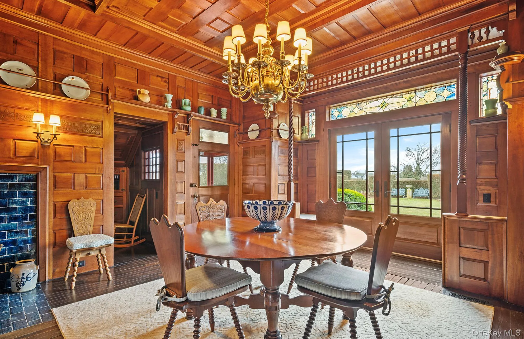 Dining room with french doors, wooden ceiling, wood walls, and wood finished floors Dining room with french doors, wooden ceiling, wood walls, and wood finished floors