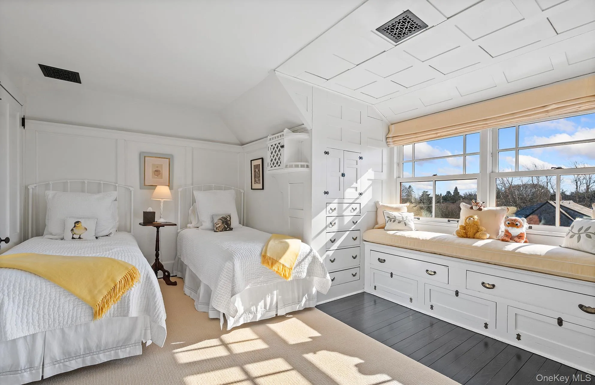 Bedroom with a decorative wall, visible vents, vaulted ceiling, and dark wood-style floors Bedroom with a decorative wall, visible vents, vaulted ceiling, and dark wood-style floors