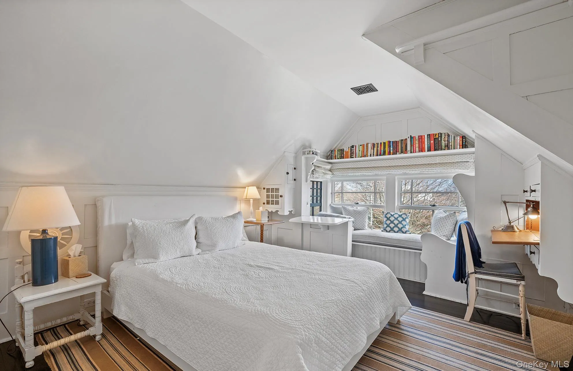 Bedroom featuring visible vents, vaulted ceiling, and wood finished floors Bedroom featuring visible vents, vaulted ceiling, and wood finished floors