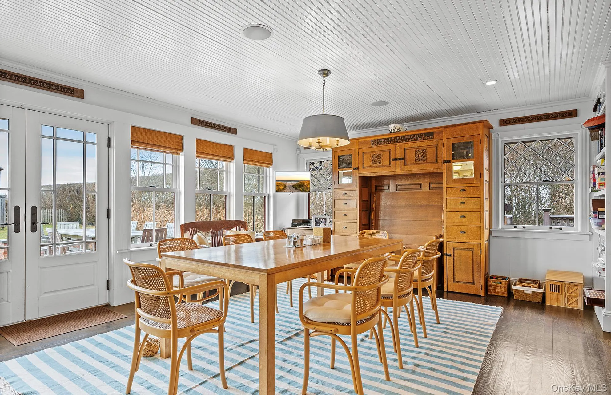 Dining room with ornamental molding and hardwood / wood-style flooring Dining room with ornamental molding and hardwood / wood-style flooring