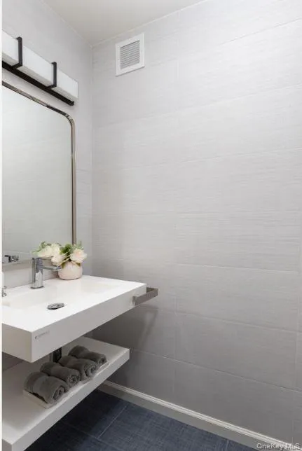 Bathroom with tile patterned flooring and visible vents Bathroom with tile patterned flooring and visible vents