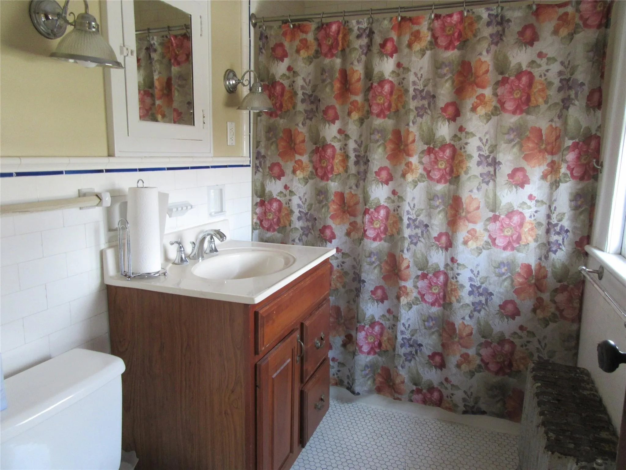 Bathroom featuring toilet, tile walls, a shower with shower curtain, and vanity Bathroom featuring toilet, tile walls, a shower with shower curtain, and vanity