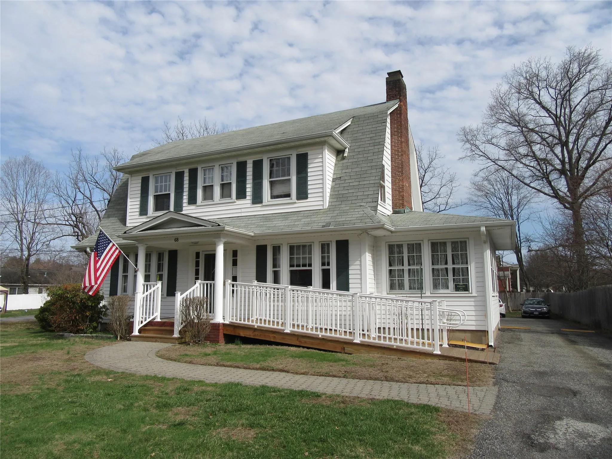 View of front of property with a chimney, covered porch, and driveway View of front of property with a chimney, covered porch, and driveway
