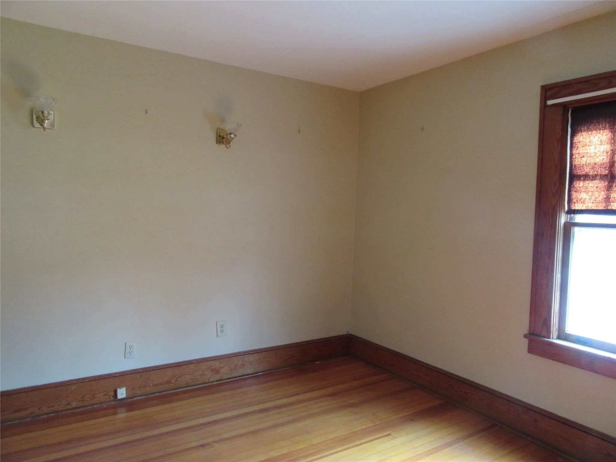 Unfurnished room featuring light wood finished floors and baseboards Unfurnished room featuring light wood finished floors and baseboards