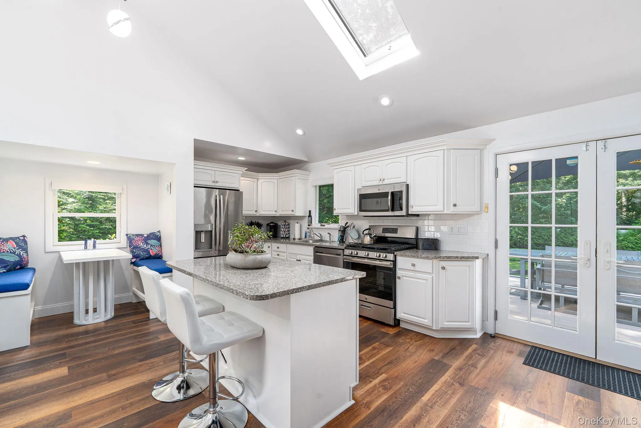 Kitchen with island and a dining nook Kitchen with island and a dining nook