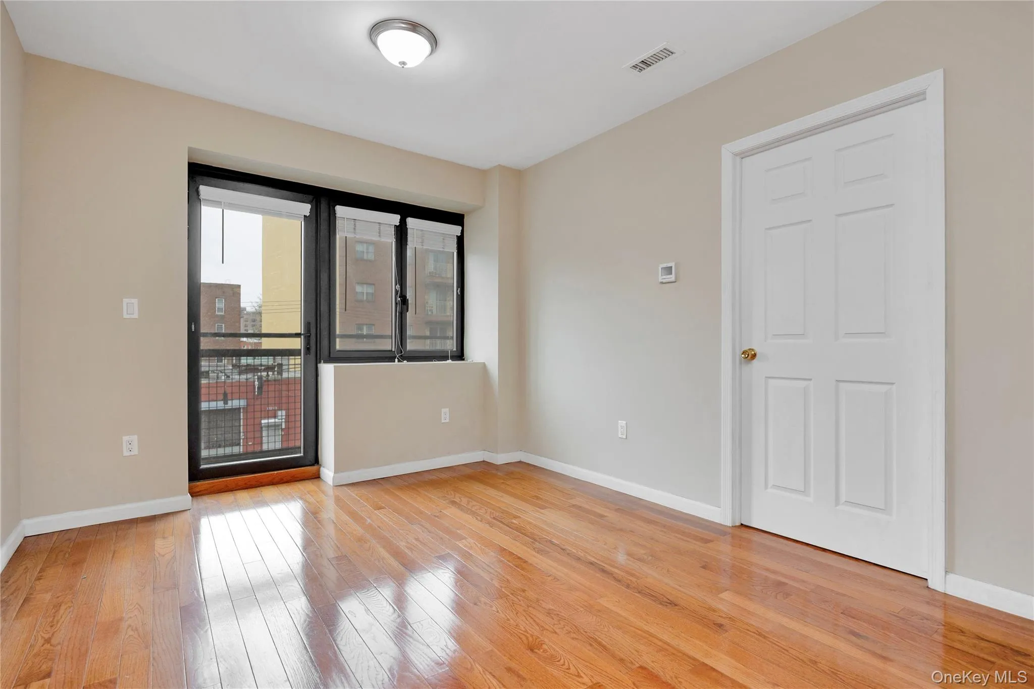 Empty room with visible vents, baseboards, and light wood-style floors Empty room with visible vents, baseboards, and light wood-style floors