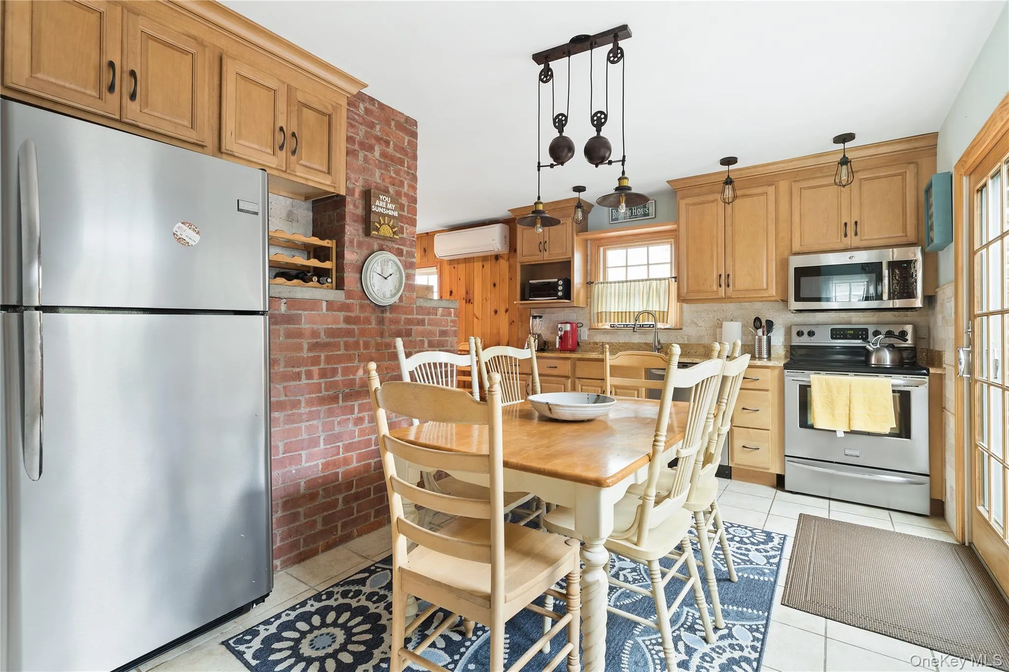 Dining area with light tile patterned floors and an AC wall unit Dining area with light tile patterned floors and an AC wall unit