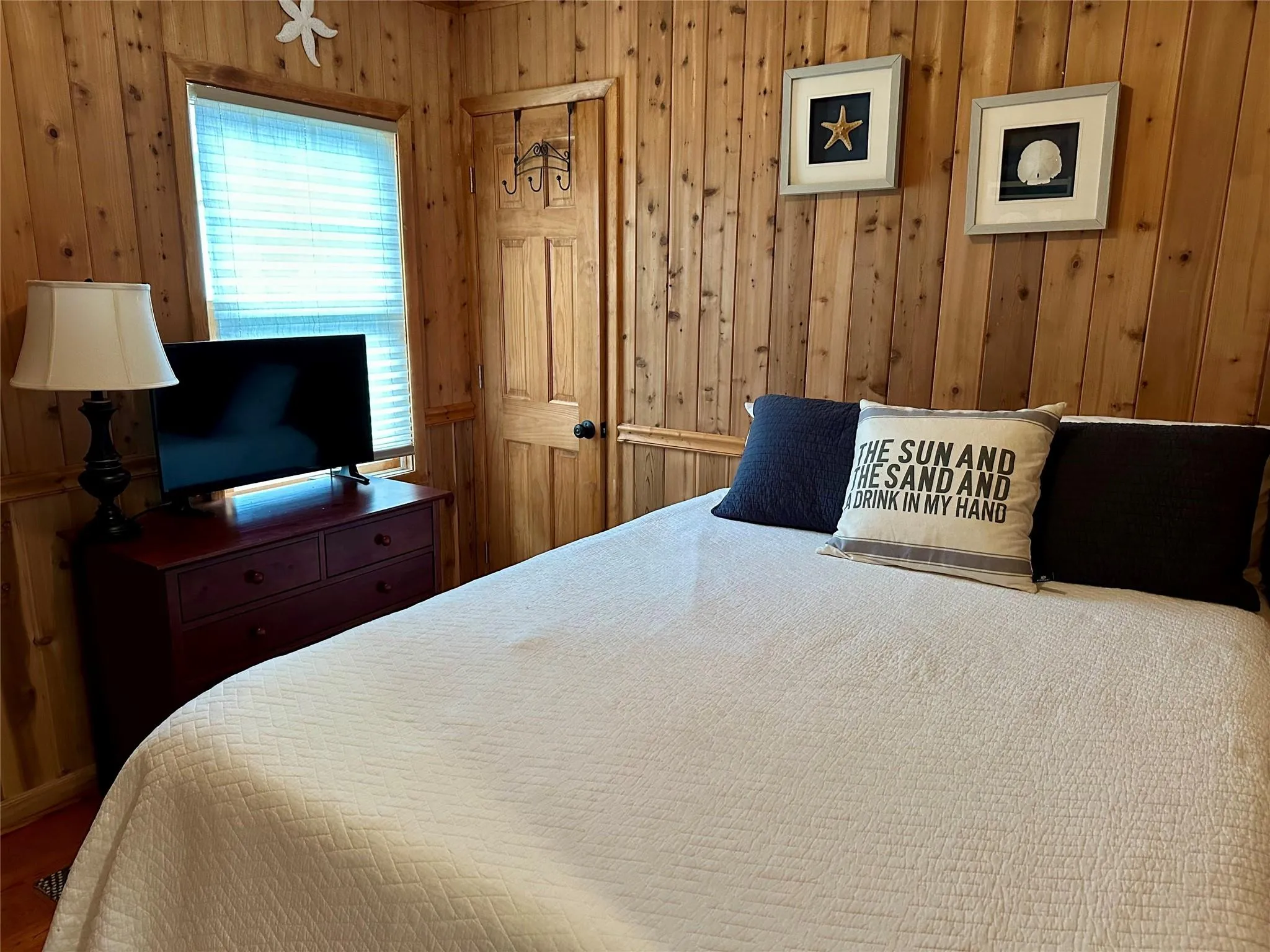 Bedroom featuring wooden walls Bedroom featuring wooden walls