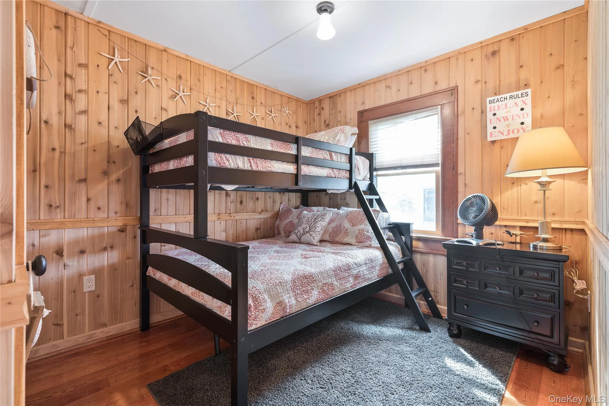 Bedroom with wooden walls and wood finished floors Bedroom with wooden walls and wood finished floors