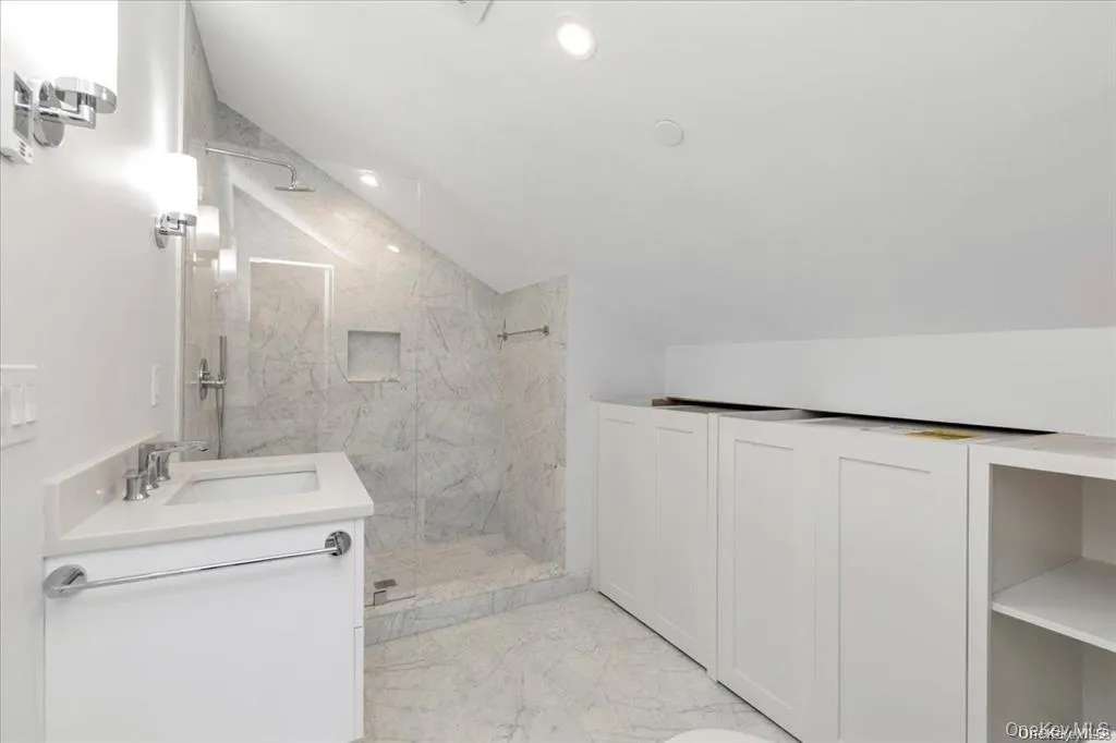 Bathroom with heated floor and full size washer and dryer in cabinets Bathroom with heated floor and full size washer and dryer in cabinets