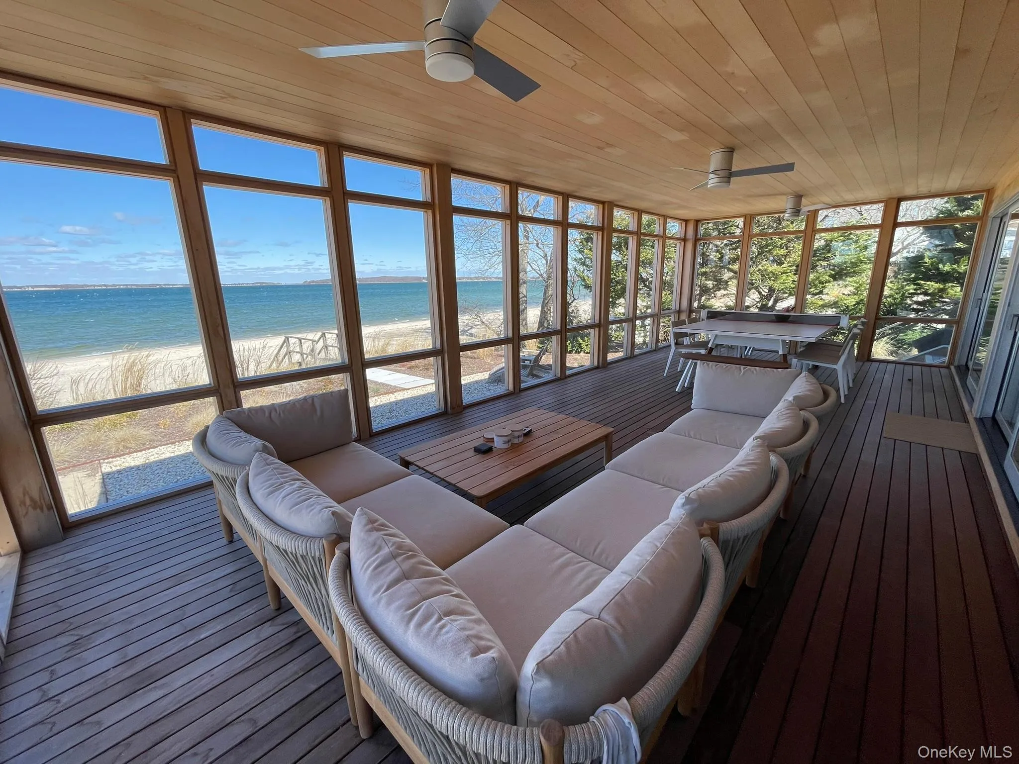 Sunroom featuring a water view, an outdoor hangout area, and ceiling fan Sunroom featuring a water view, an outdoor hangout area, and ceiling fan