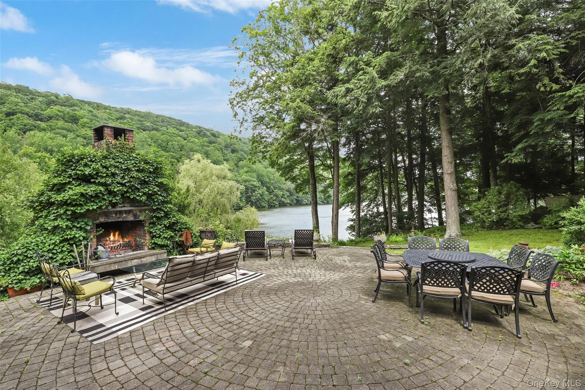 View of patio with views of lake and wooded hillsides. View of patio with views of lake and wooded hillsides.