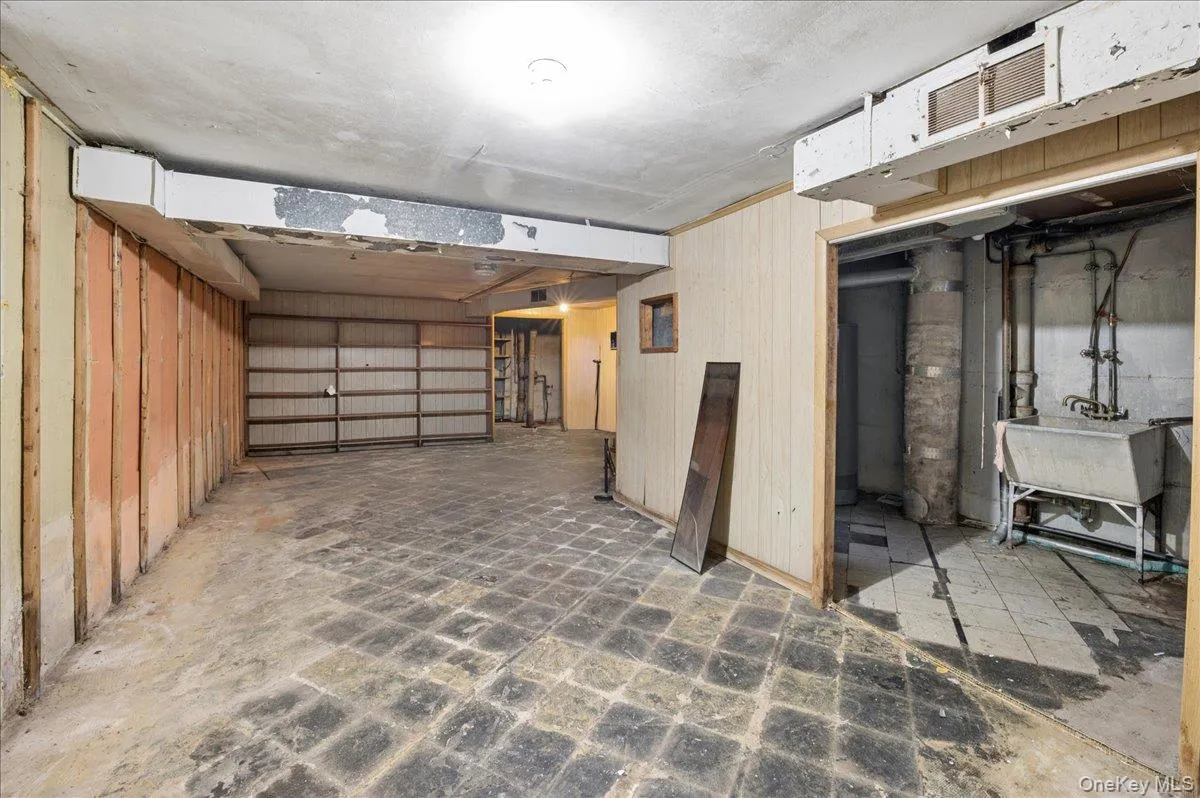 Spacious unfinished lower level featuring exposed framing and a large utility sink Spacious unfinished lower level featuring exposed framing and a large utility sink