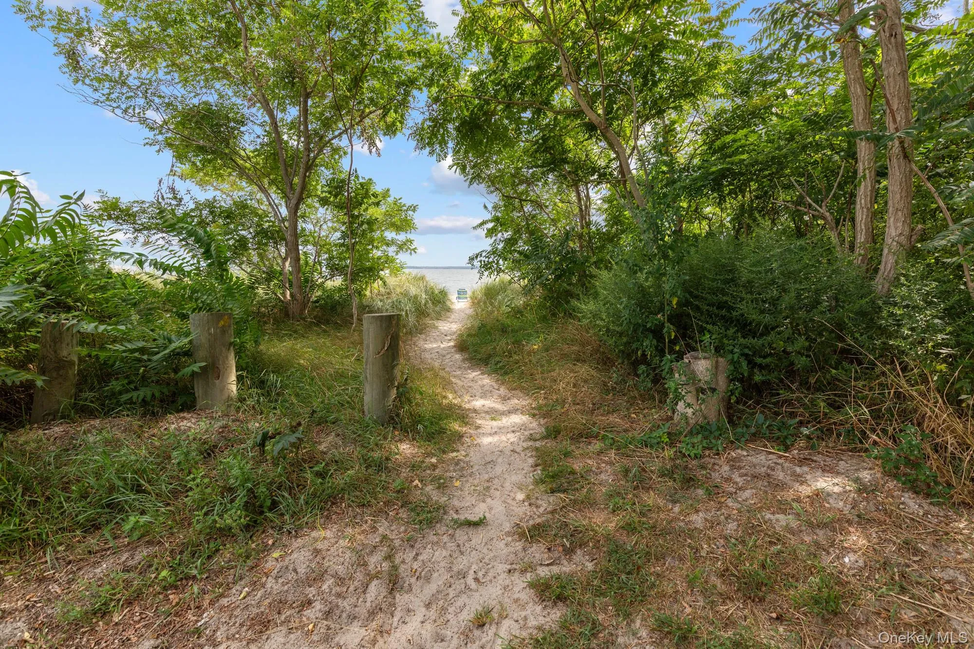 View of road with view of water and beach View of road with view of water and beach