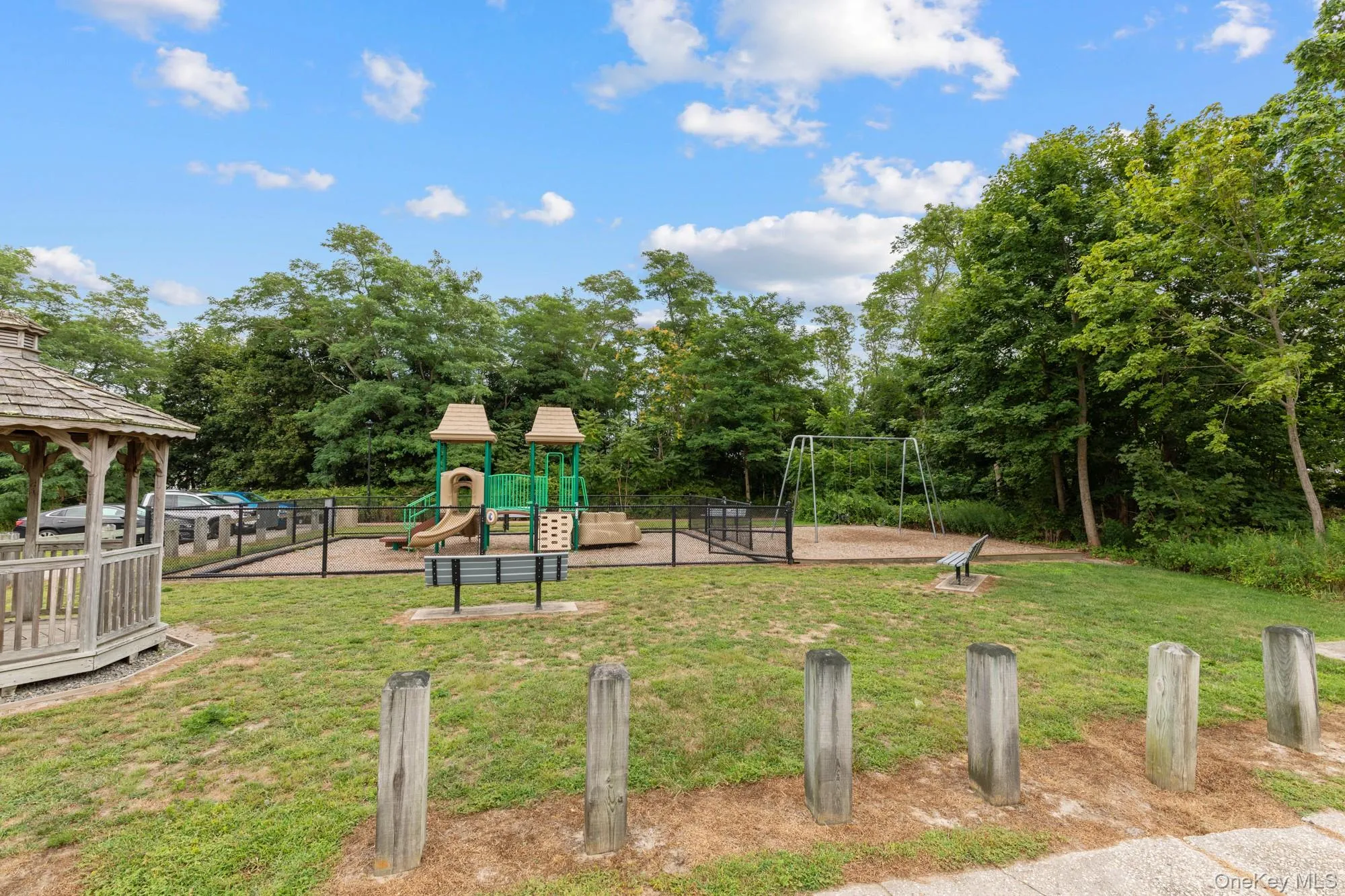 Community play area featuring a gazebo, a yard, and view of wooded area Community play area featuring a gazebo, a yard, and view of wooded area