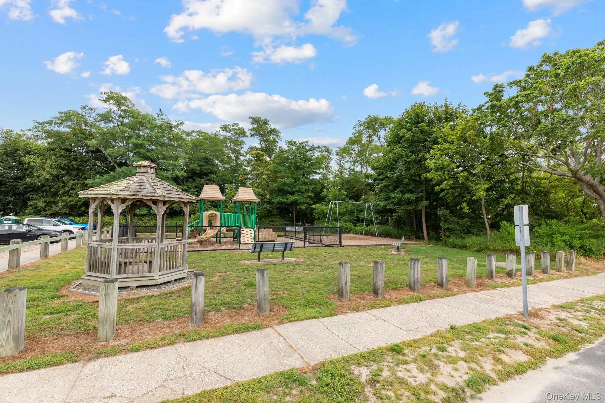 View of community featuring a gazebo, a yard, and view of wooded area View of community featuring a gazebo, a yard, and view of wooded area