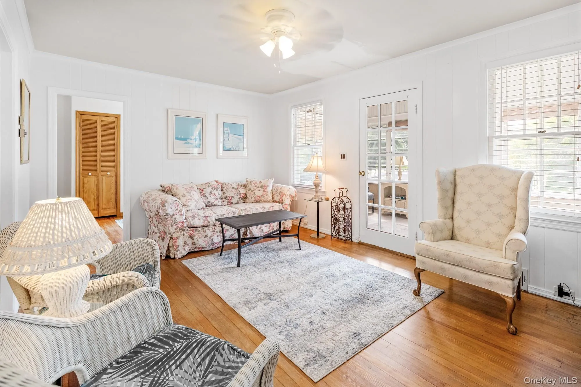 Living area with crown molding, hardwood / wood-style floors, and a ceiling fan Living area with crown molding, hardwood / wood-style floors, and a ceiling fan