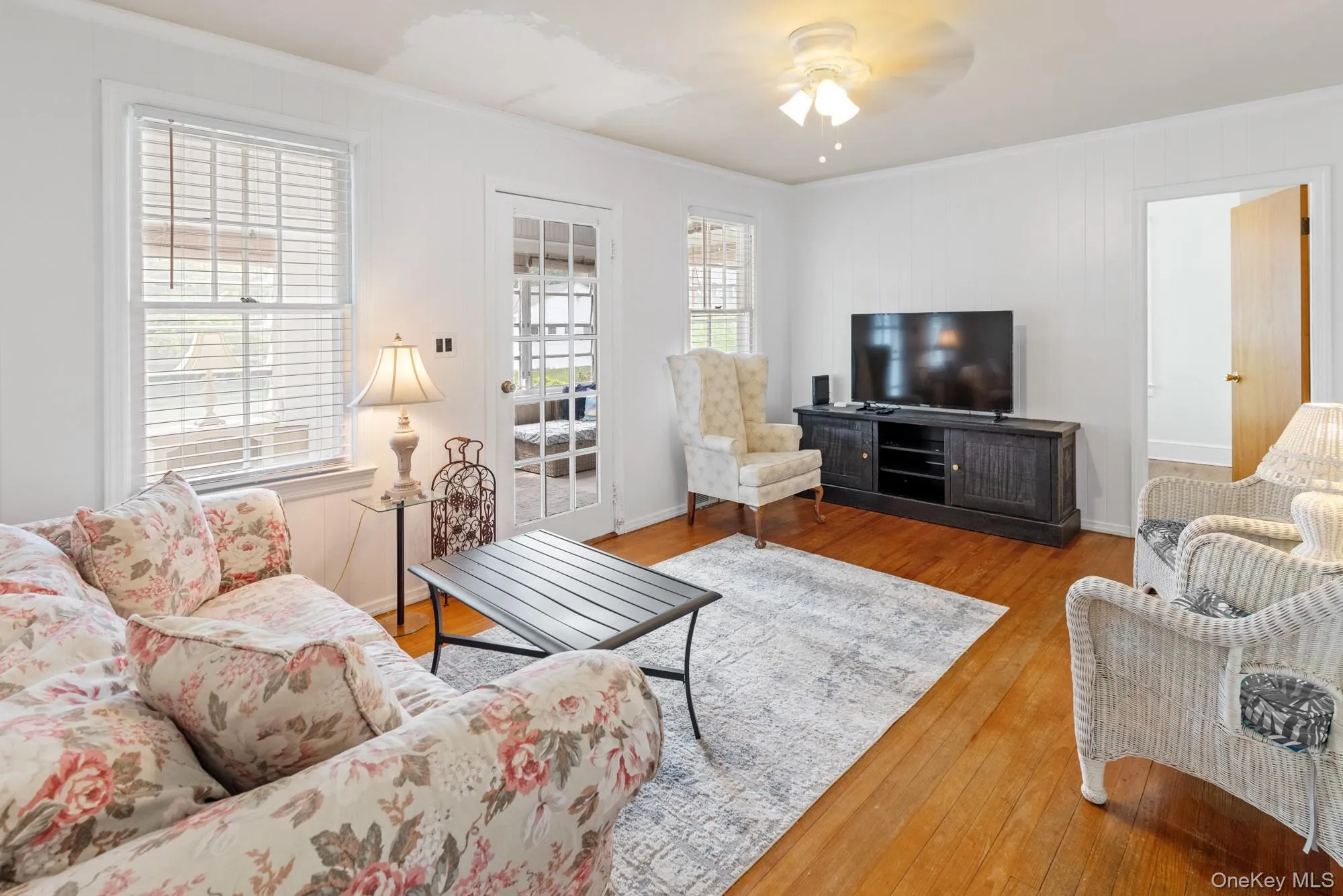 Living area featuring hardwood / wood-style flooring, crown molding, and ceiling fan Living area featuring hardwood / wood-style flooring, crown molding, and ceiling fan