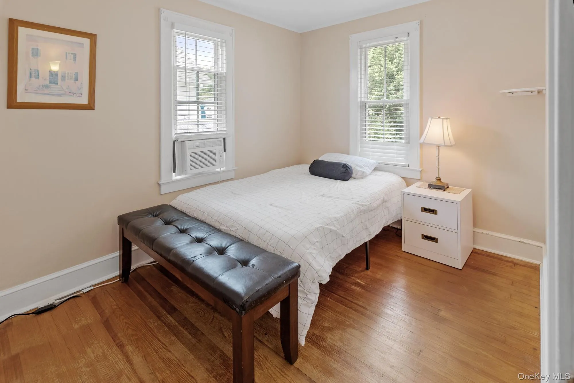 Bedroom featuring ornamental molding and light wood-style floors Bedroom featuring ornamental molding and light wood-style floors