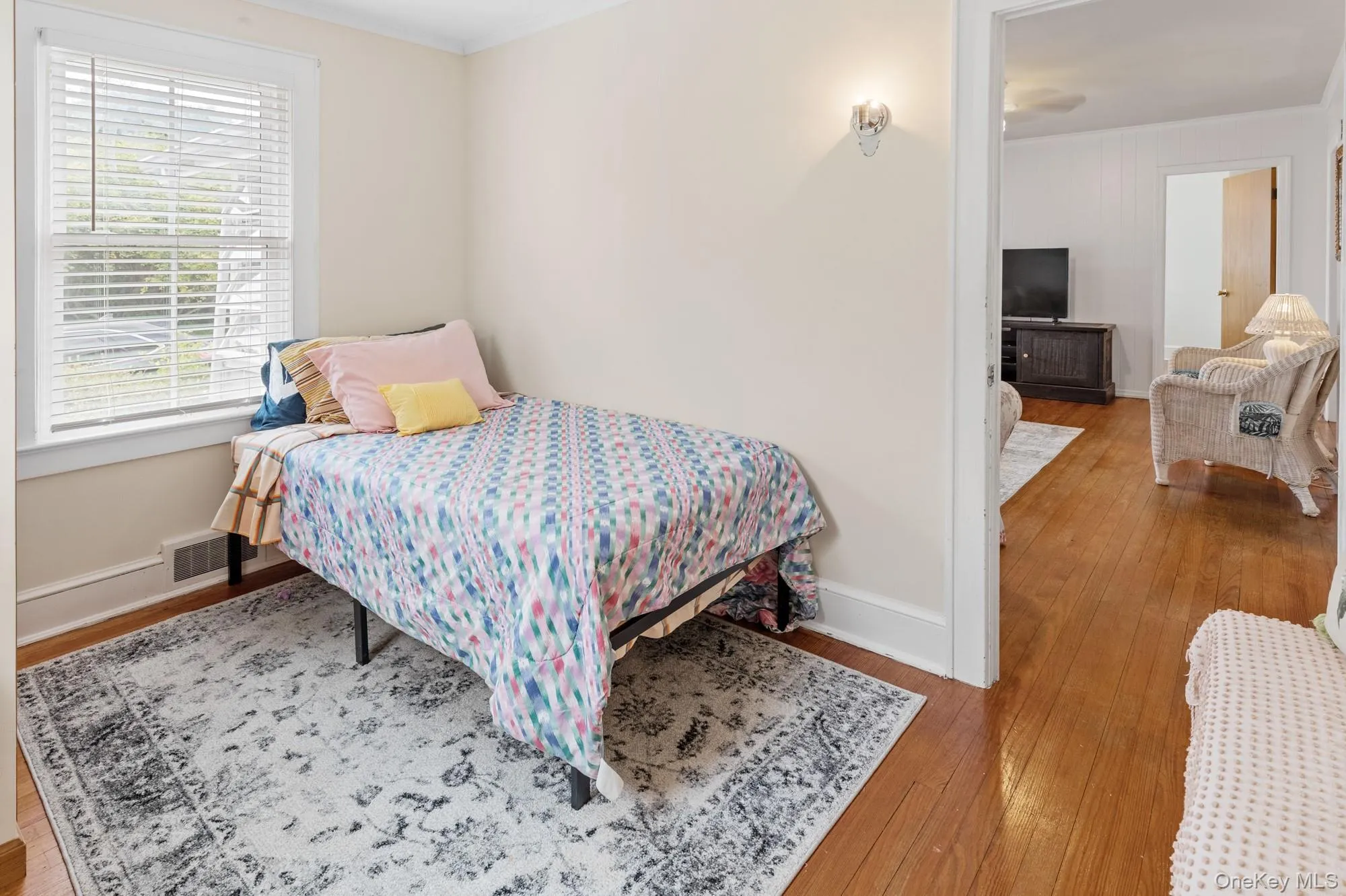 Bedroom featuring crown molding and hardwood / wood-style floors Bedroom featuring crown molding and hardwood / wood-style floors