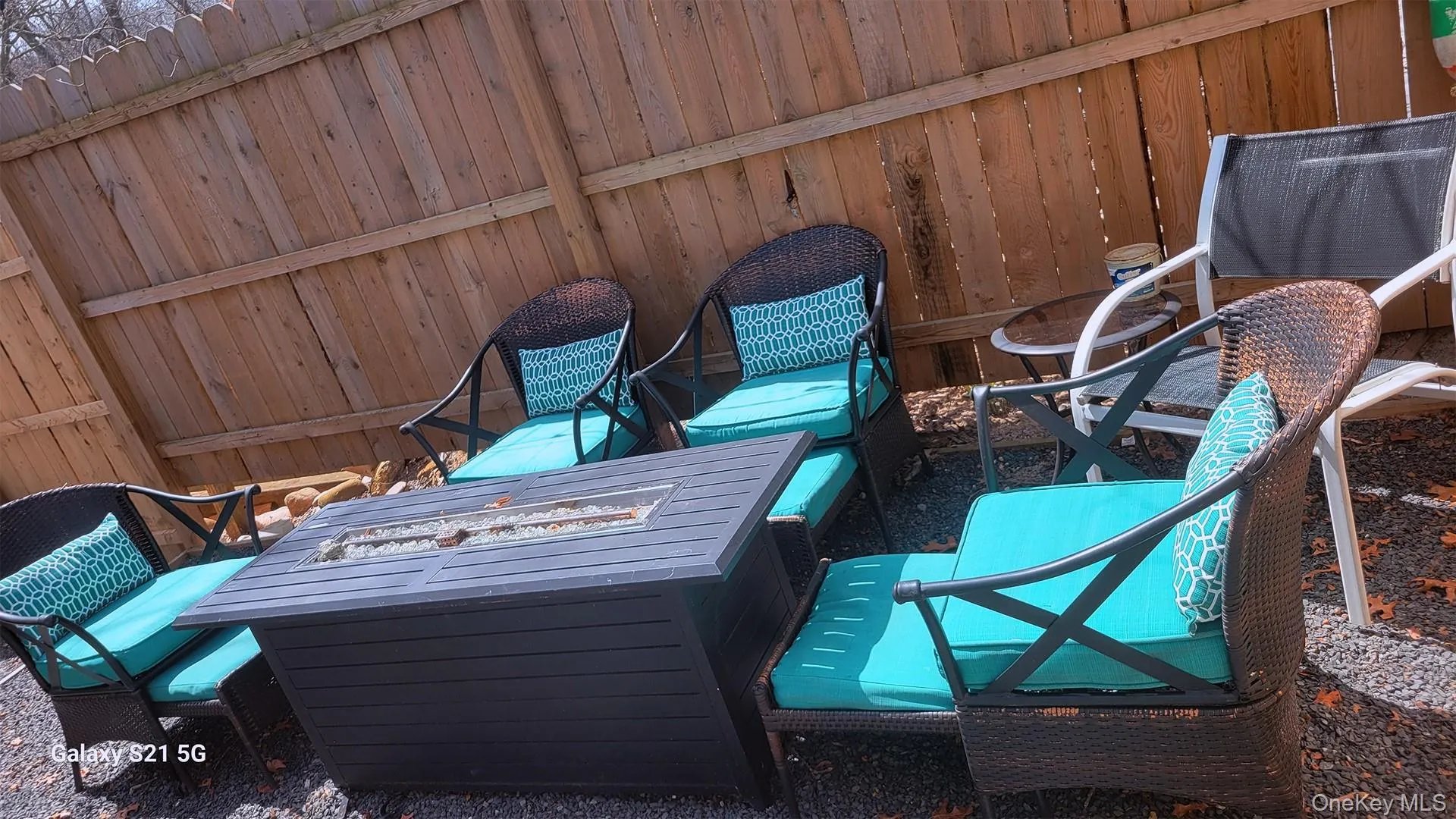 View of patio featuring fence and an outdoor fire pit View of patio featuring fence and an outdoor fire pit