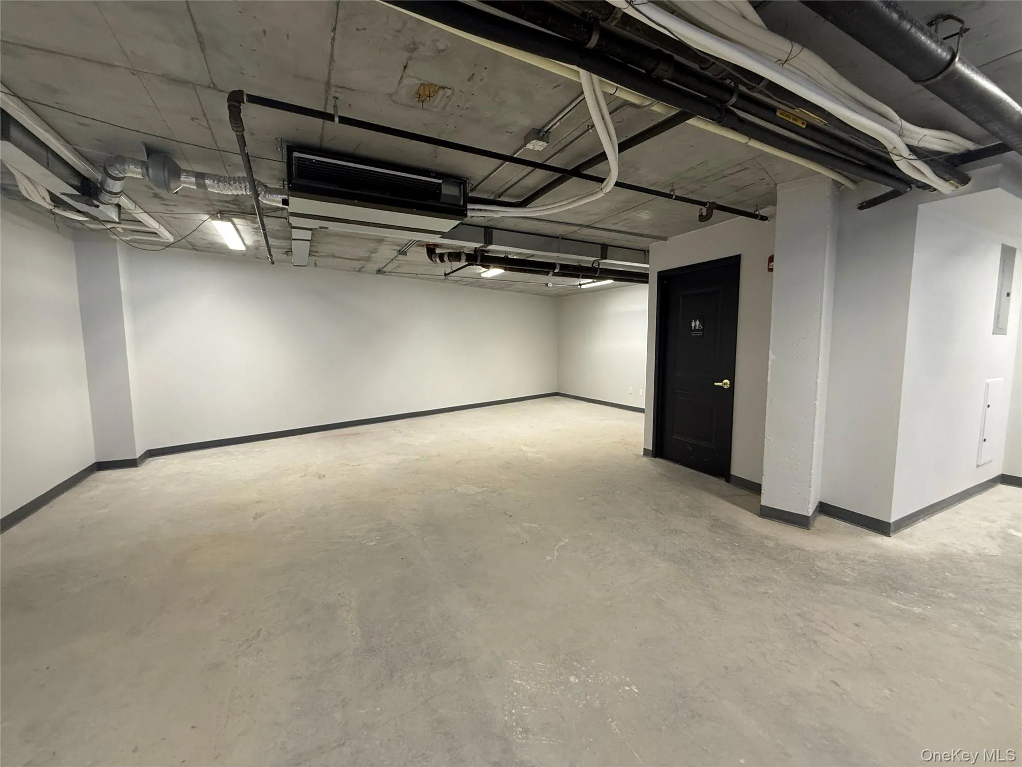 Below grade area with baseboards and electric panel Below grade area with baseboards and electric panel