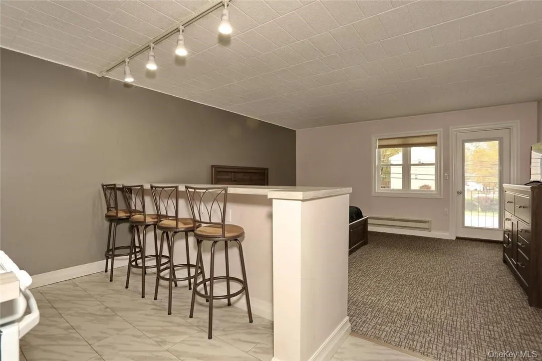 The eating counter overlooks the living/sleeping area. The eating counter overlooks the living/sleeping area.
