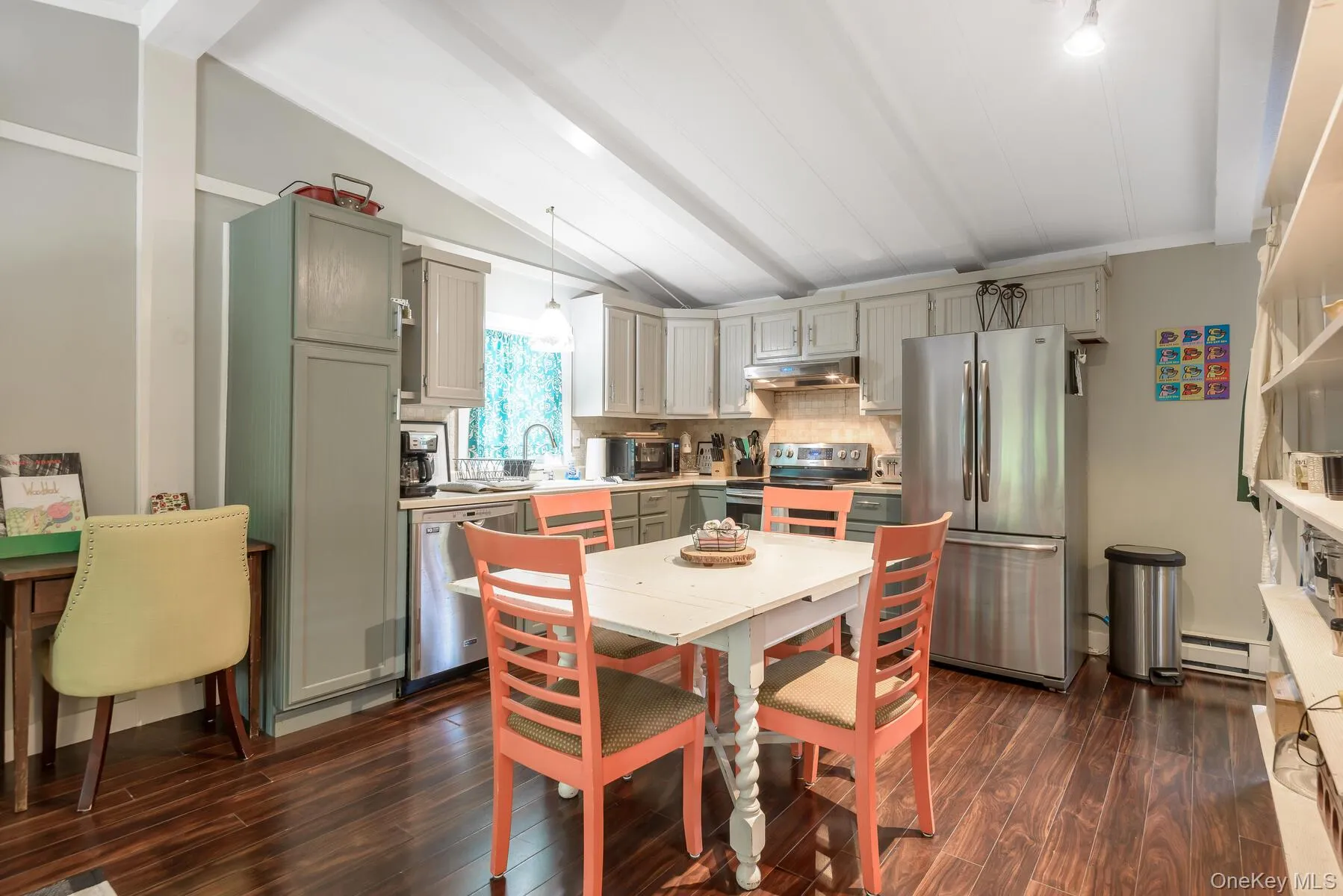 Dining space featuring dark wood-style flooring, lofted ceiling with beams, and baseboard heating Dining space featuring dark wood-style flooring, lofted ceiling with beams, and baseboard heating