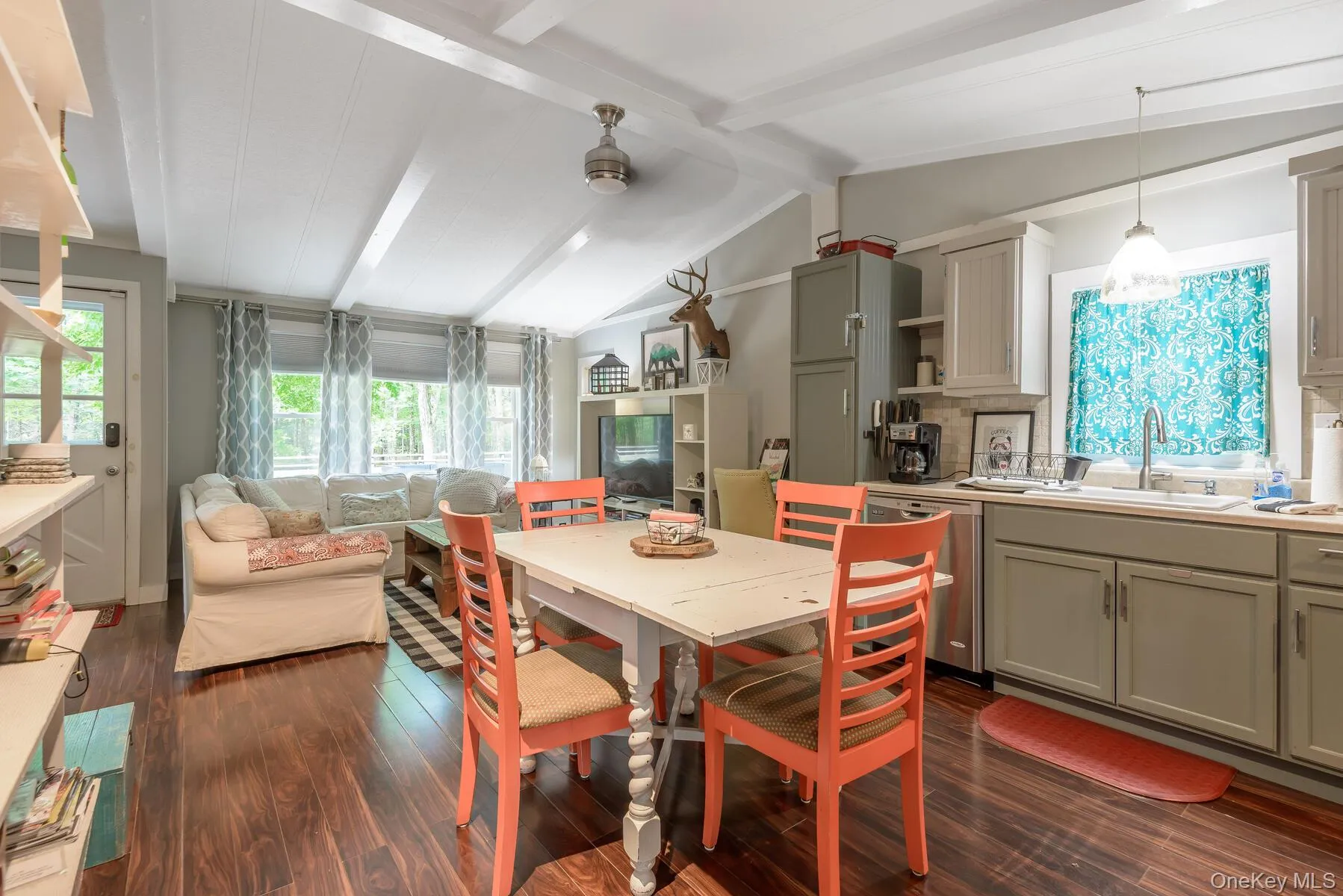Dining room with dark wood-style flooring and lofted ceiling with beams Dining room with dark wood-style flooring and lofted ceiling with beams