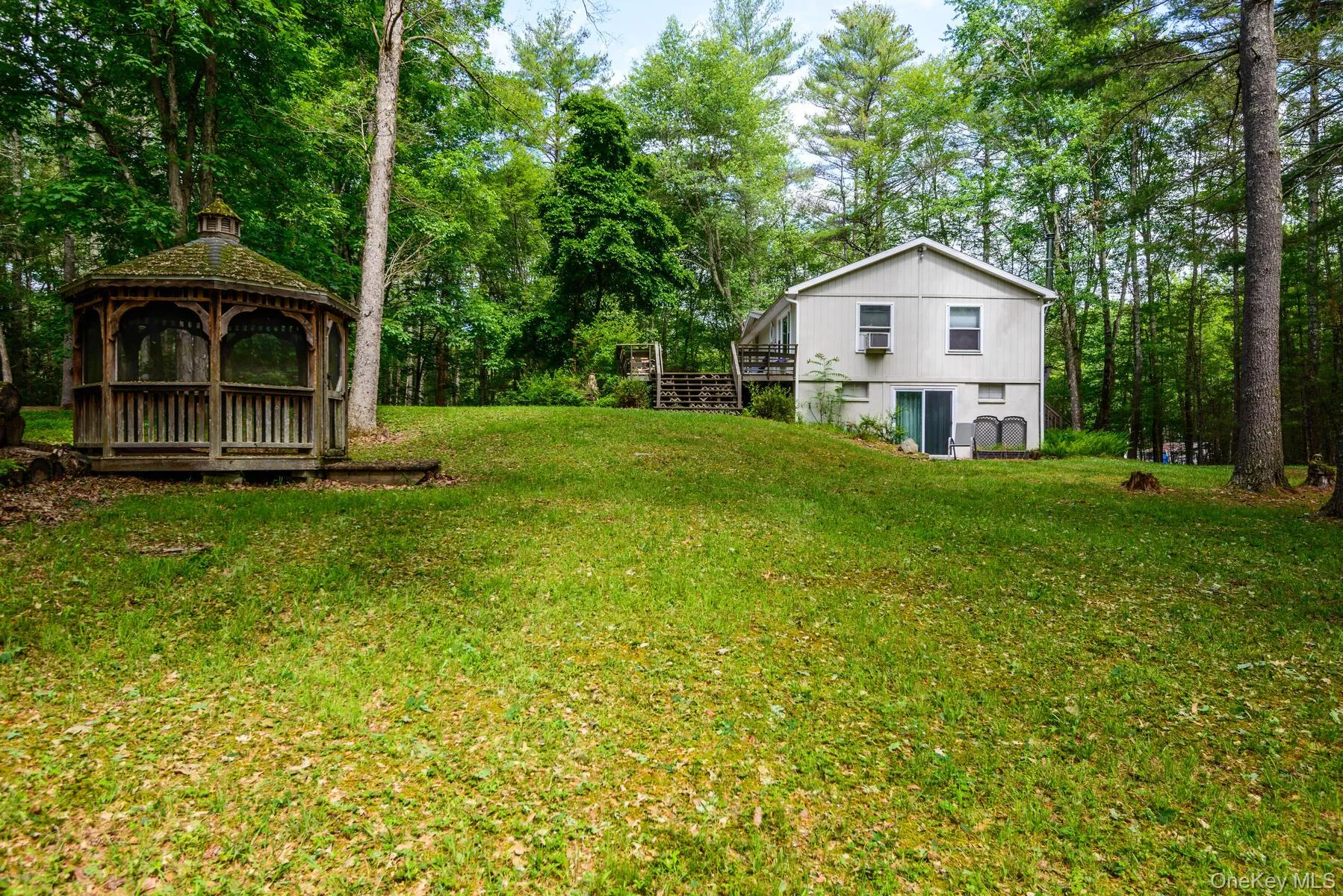 View of yard featuring a gazebo and a deck View of yard featuring a gazebo and a deck