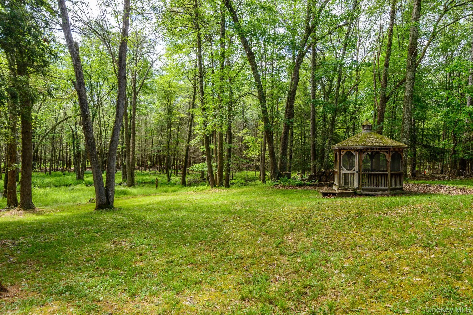 View of yard featuring a gazebo and a forest view View of yard featuring a gazebo and a forest view