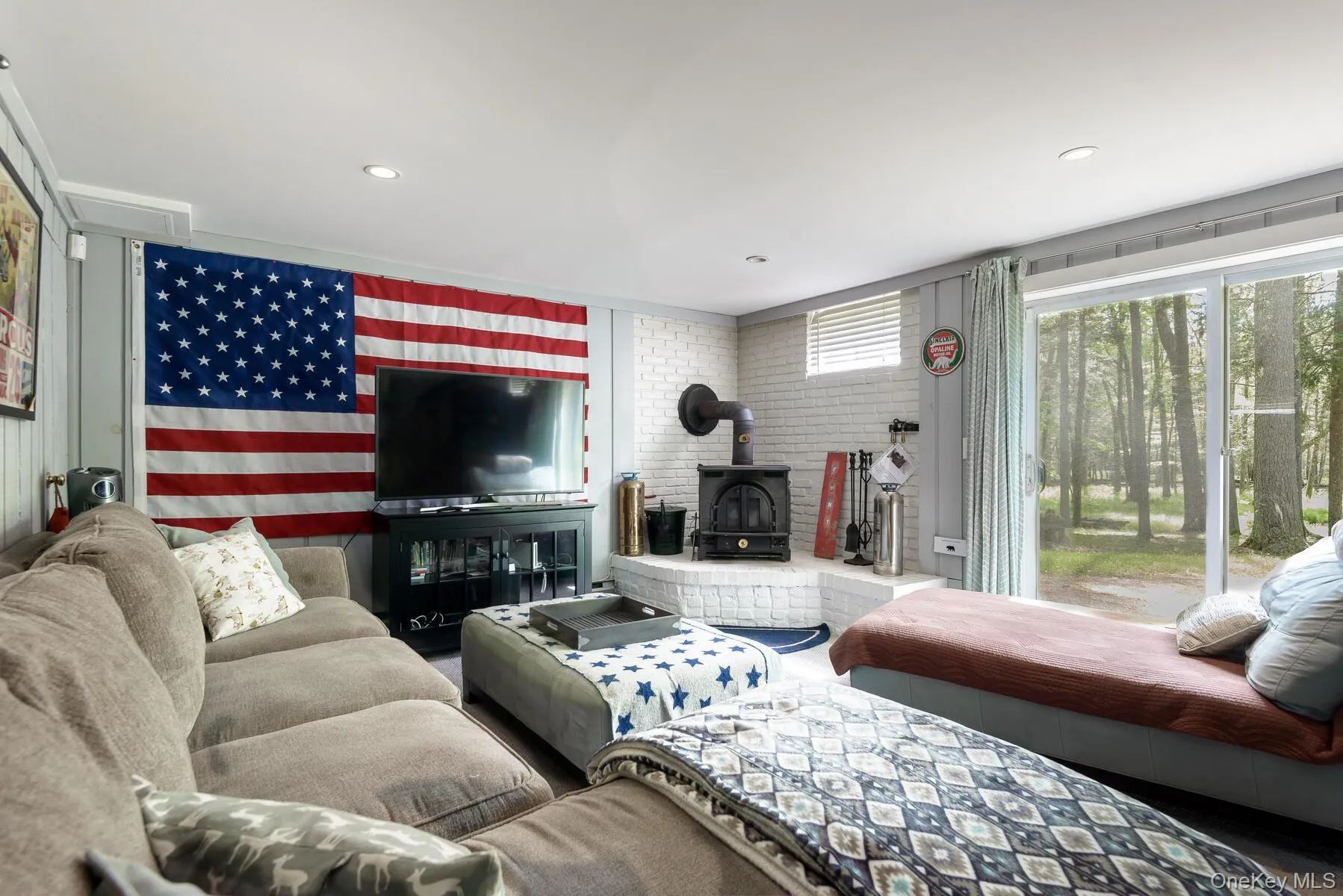 Living room featuring a wood stove and recessed lighting Living room featuring a wood stove and recessed lighting