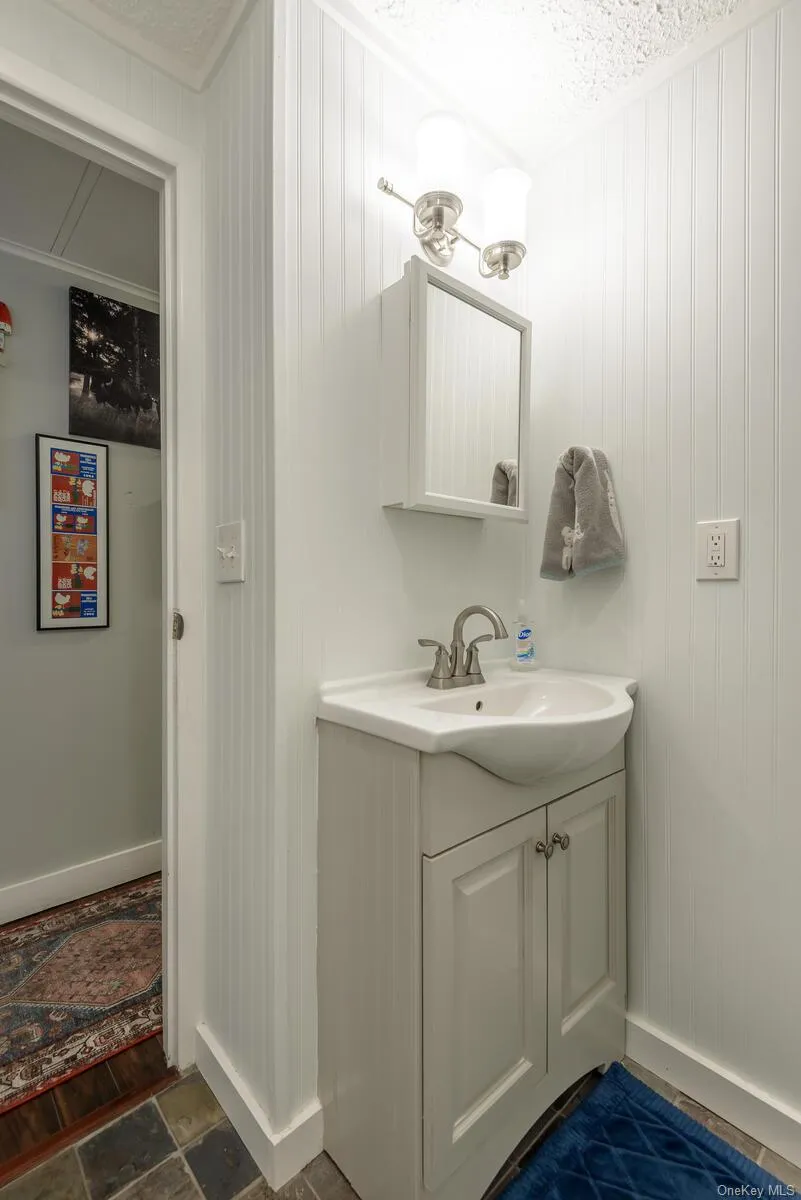 Bathroom featuring vanity and baseboards Bathroom featuring vanity and baseboards