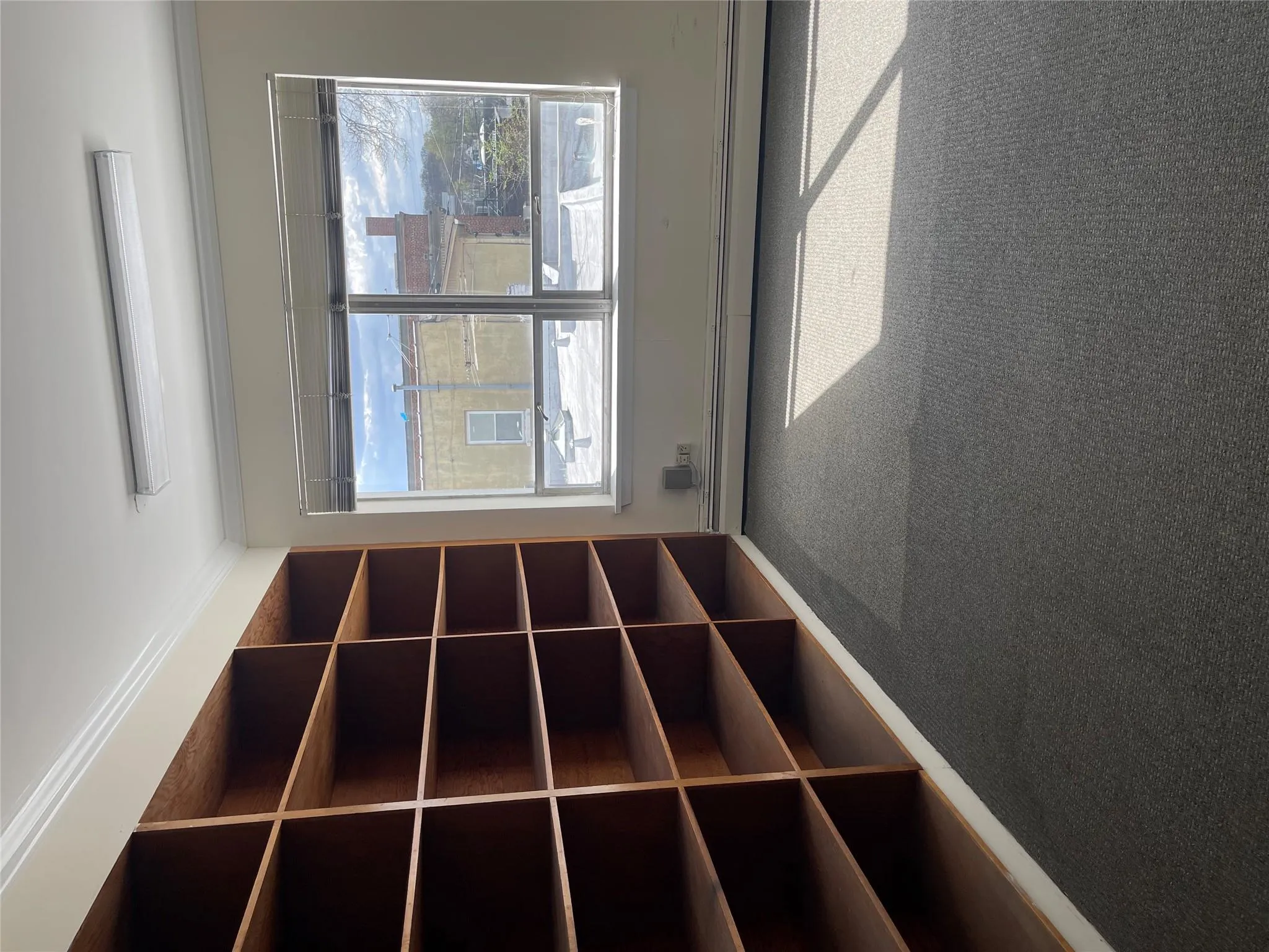 Carpeted empty room featuring baseboard heating and crown molding Carpeted empty room featuring baseboard heating and crown molding