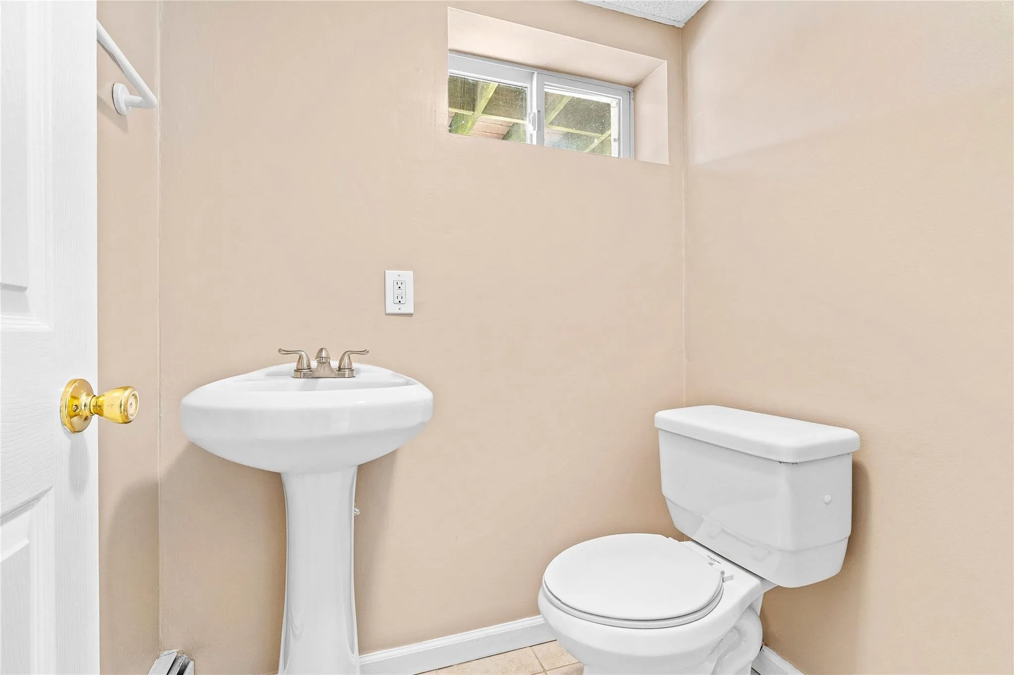 Bathroom with baseboards, tile patterned flooring, and toilet Bathroom with baseboards, tile patterned flooring, and toilet