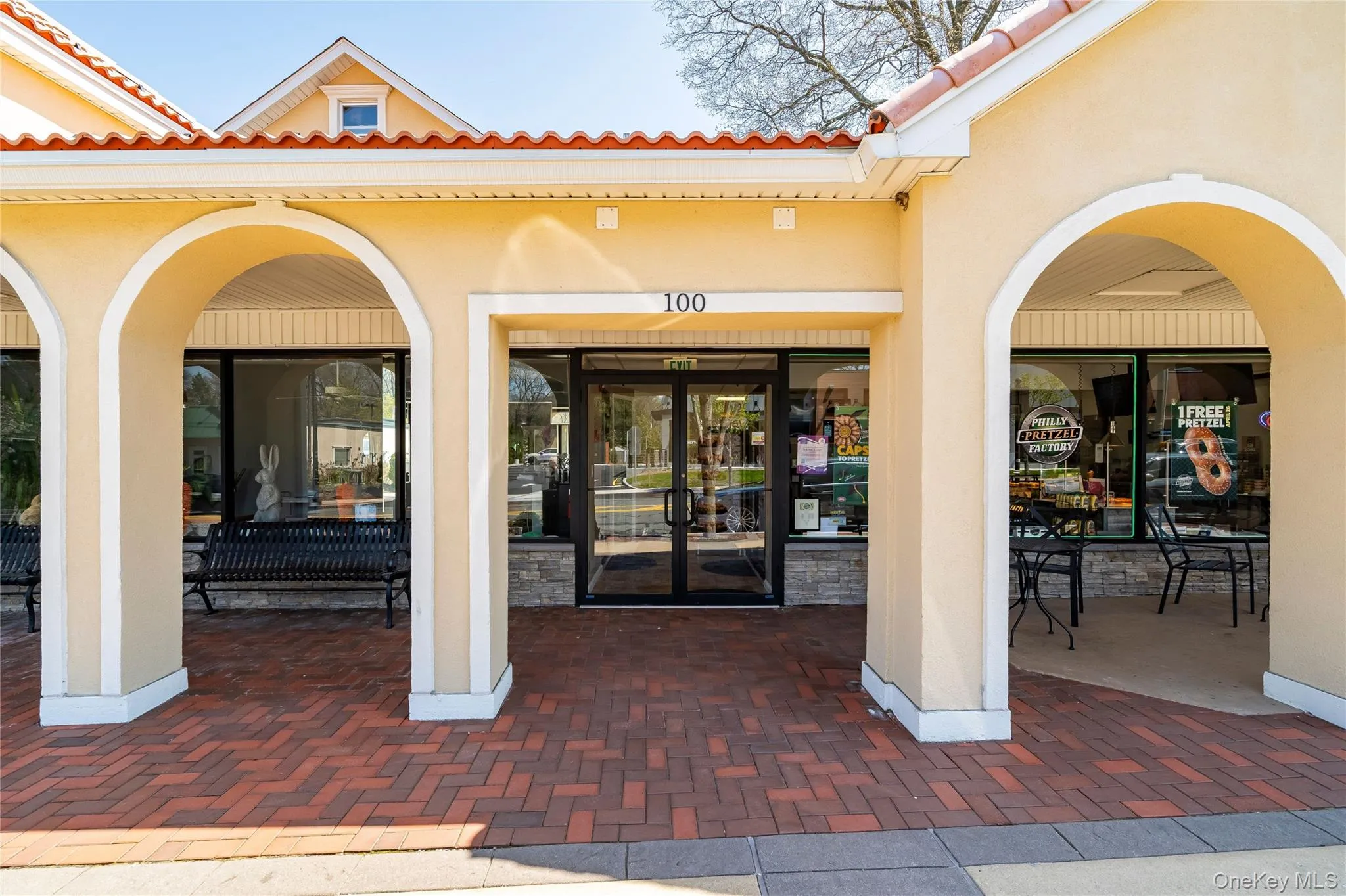 Property entrance featuring stucco siding, a tiled roof, and french doors Property entrance featuring stucco siding, a tiled roof, and french doors