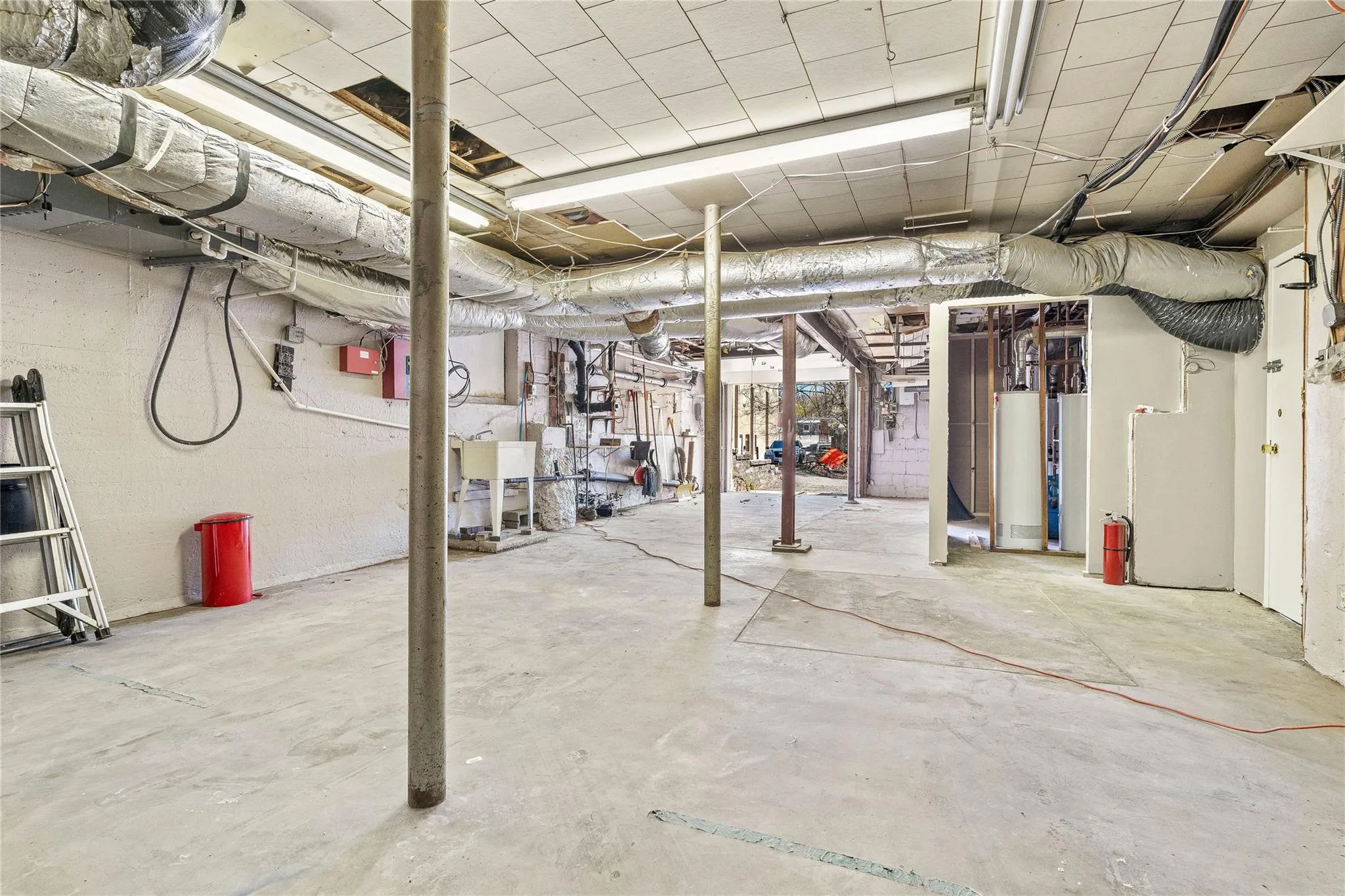 Unfinished below grade area featuring water heater Unfinished below grade area featuring water heater