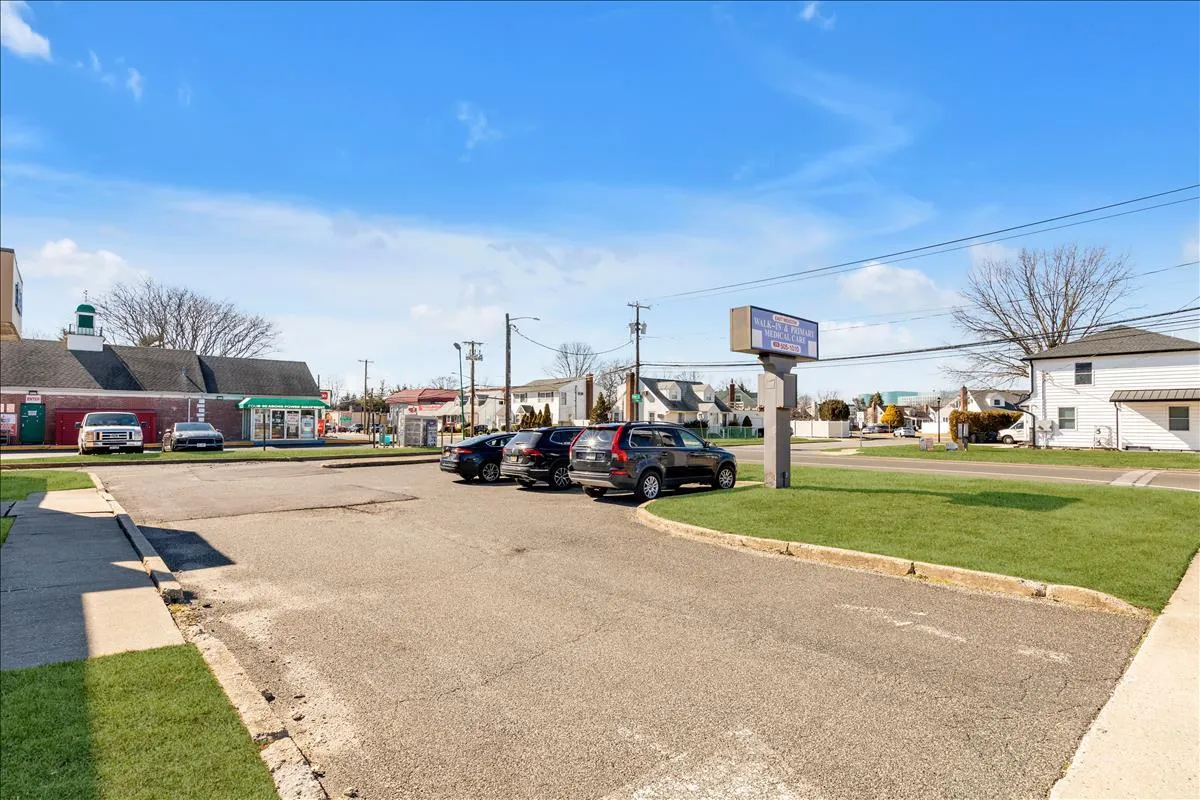 View of street featuring street lights and curbs View of street featuring street lights and curbs